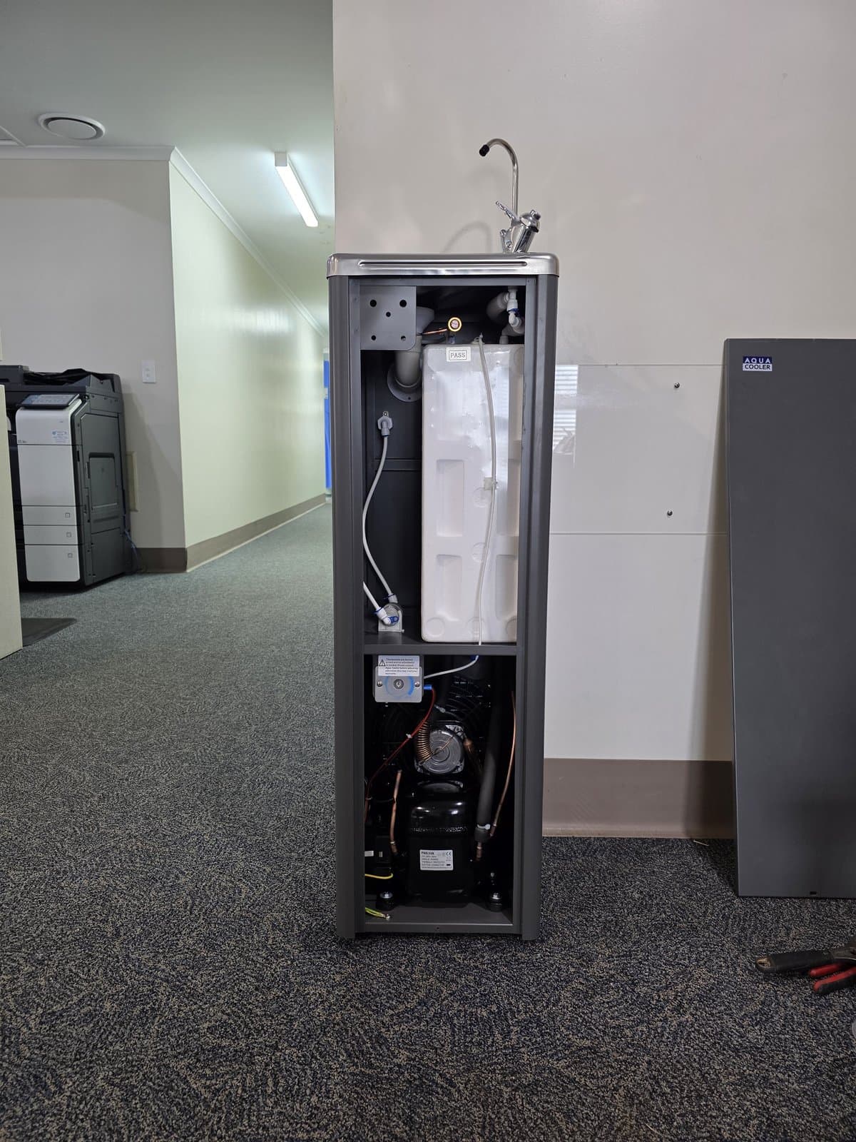 Internal plumbing and refrigeration components of a commercial drink fountain during installation