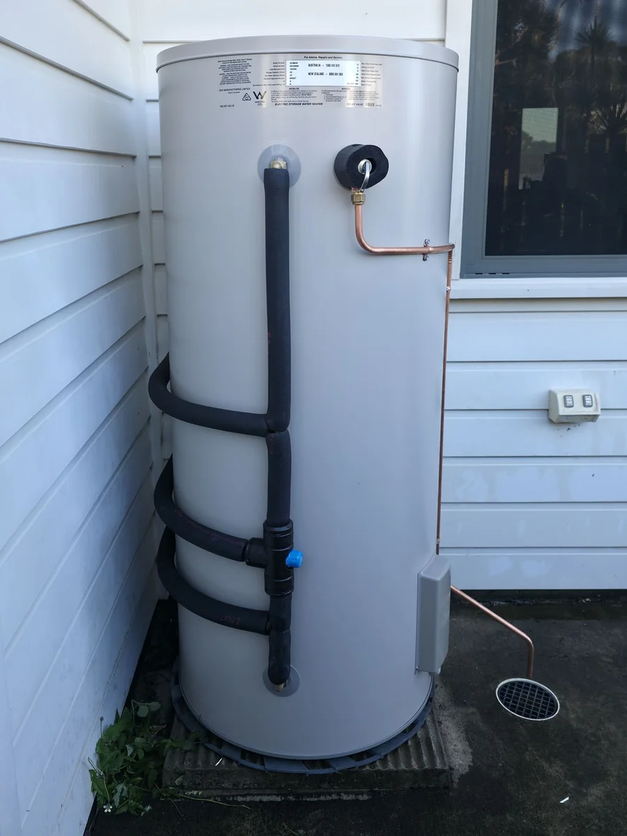Thermann electric storage hot water system mounted against a Yeppoon weatherboard wall by LTH Plumbing