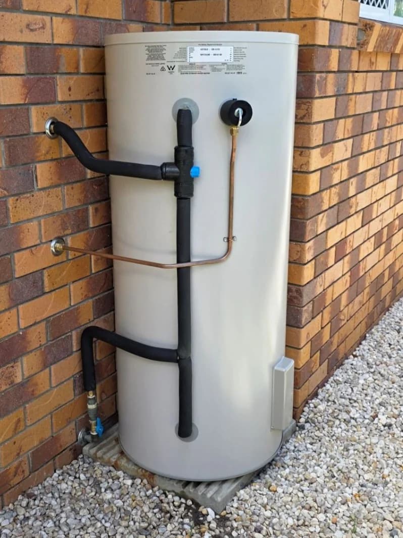 Thermann electric storage hot water system installed against a brick wall in Yeppoon by LTH Plumbing